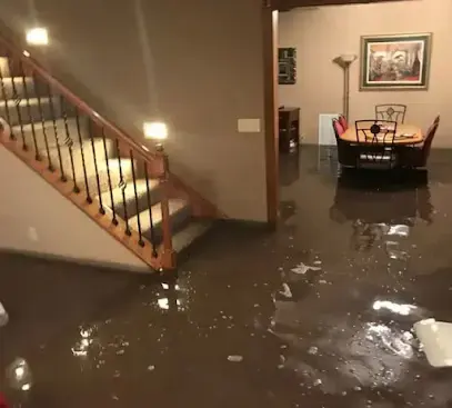 Standing water across a first floor by the stairs before extraction, Granada Hills water damage